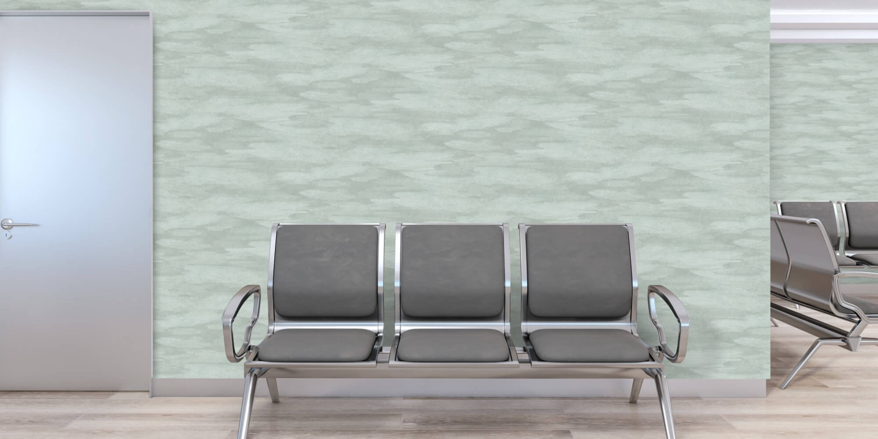 A waiting room featuring several chairs arranged neatly and a door leading to another area.