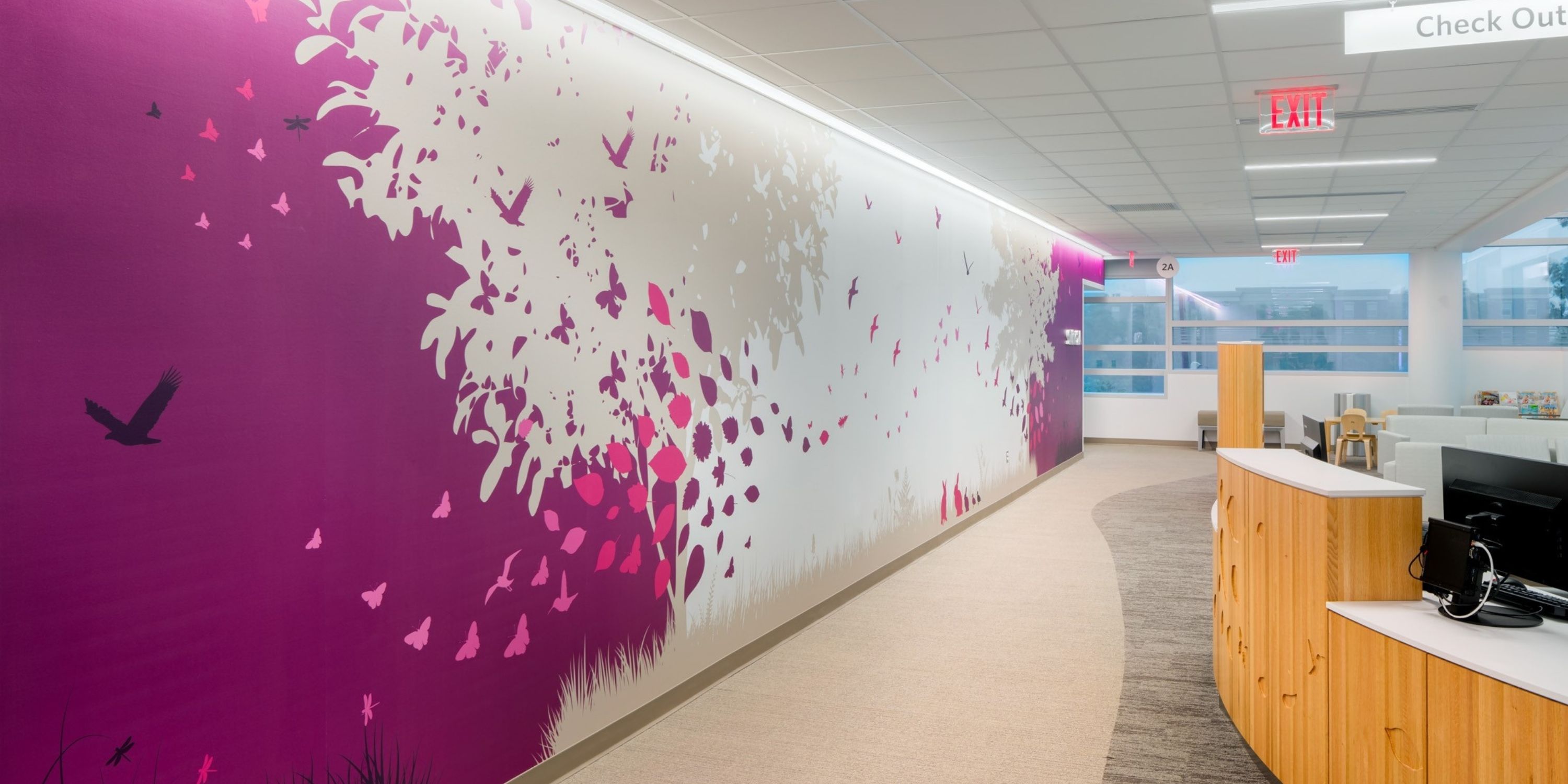 A hallway featuring a vibrant mural depicting various grasses along the walls.