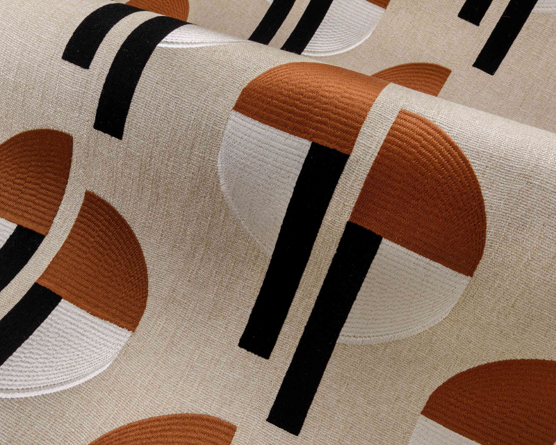 Abstract textile pattern featuring brown and beige semicircles intersected by bold black lines on a textured fabric. The design is modern and geometric.